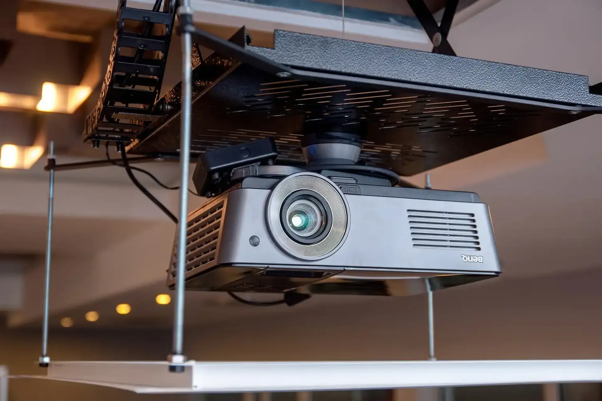 A projector mounted to a motorised mechanism lowered from the ceiling