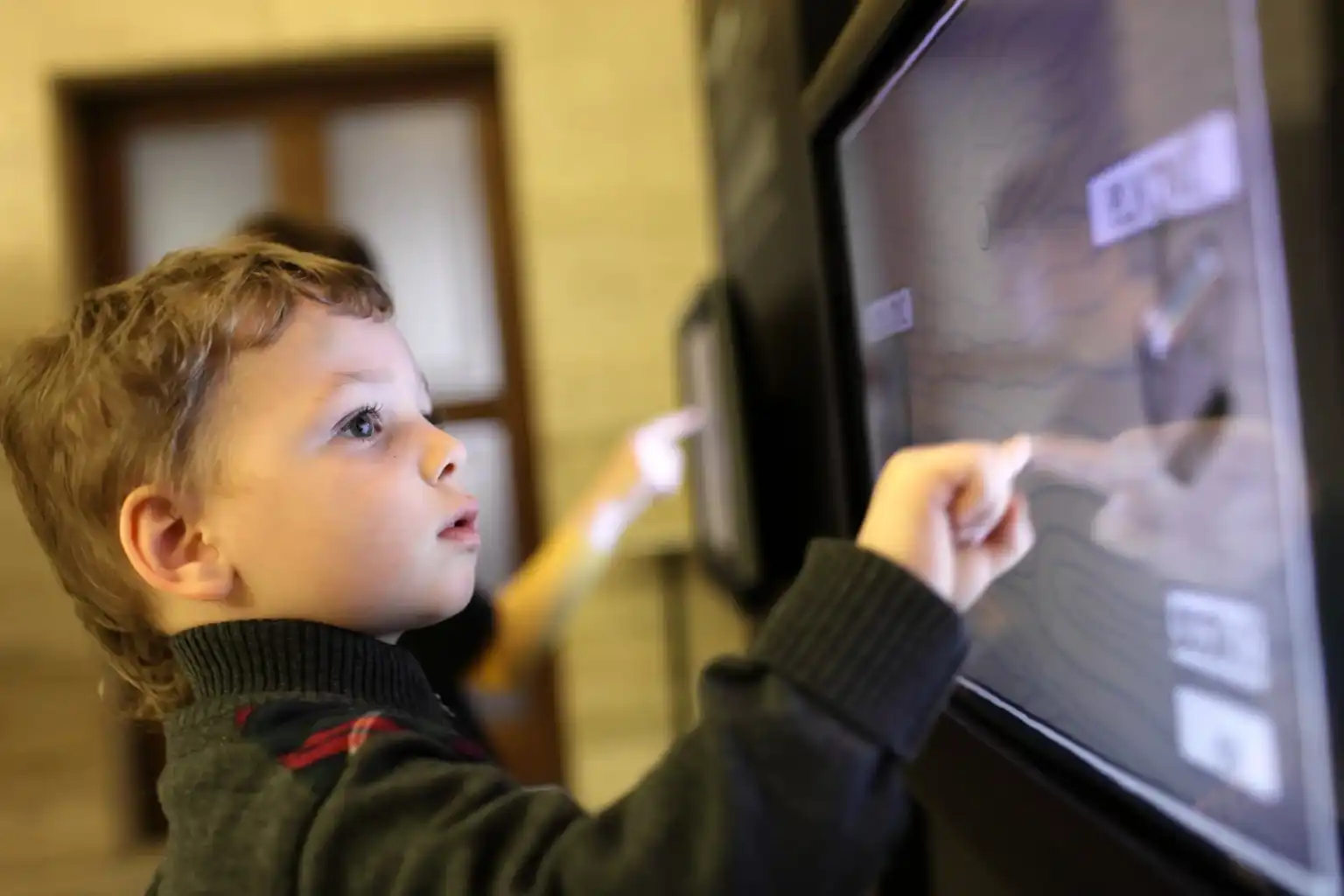 A child interacting with a touchscreen display